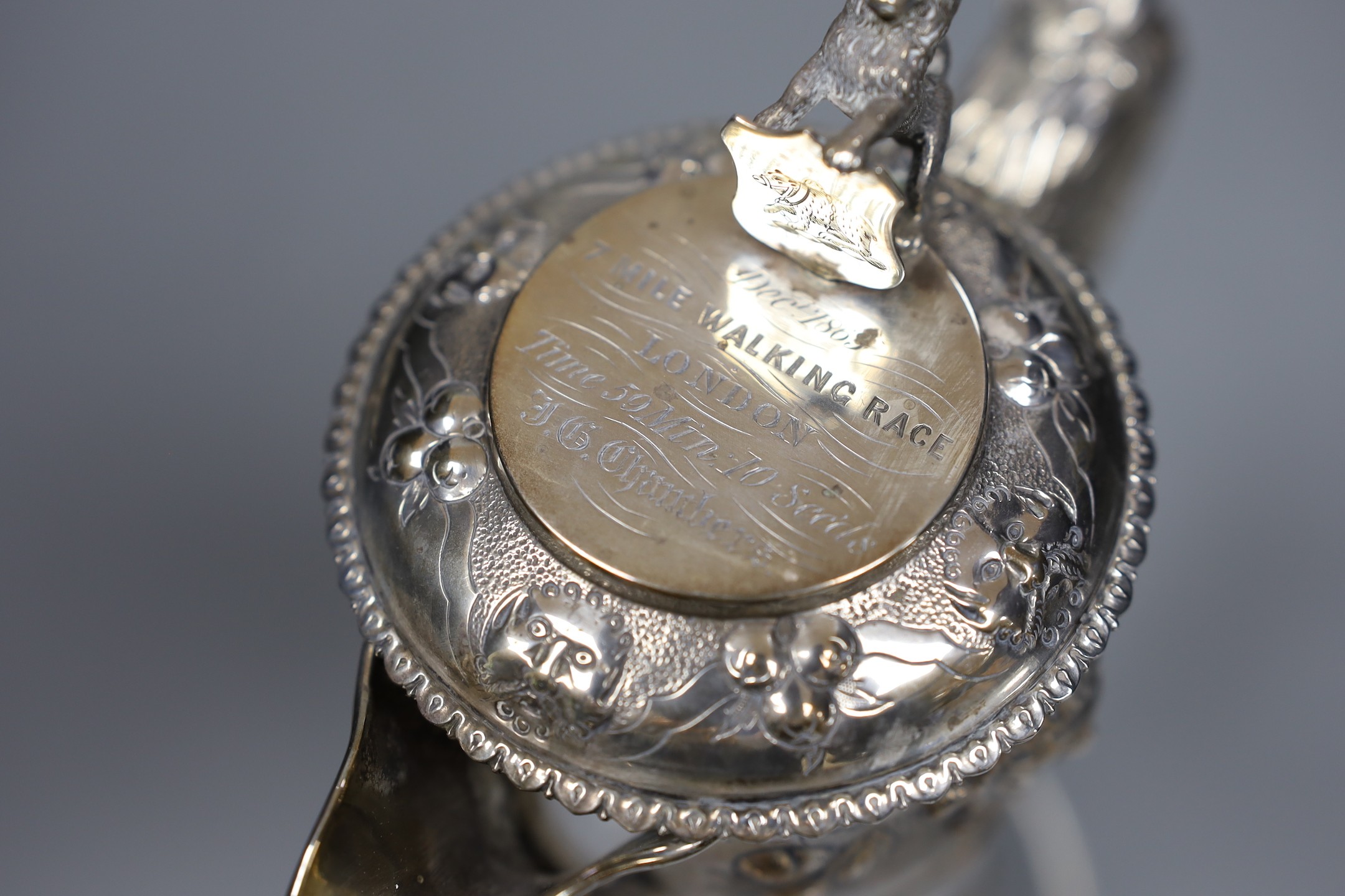 A Victorian silver mounted glass claret jug, by Richards & Brown, London, 1862, 26.9cm, decorated with masks and lion finial.